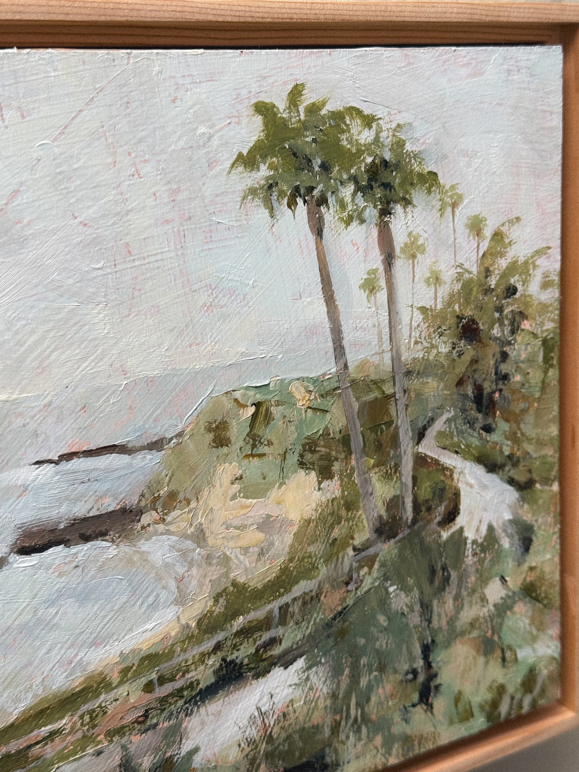 An acrylic painting in a floater wood frame, depicting the view of Treasure Island from the Montage Resort in Laguna Beach, CA. 
