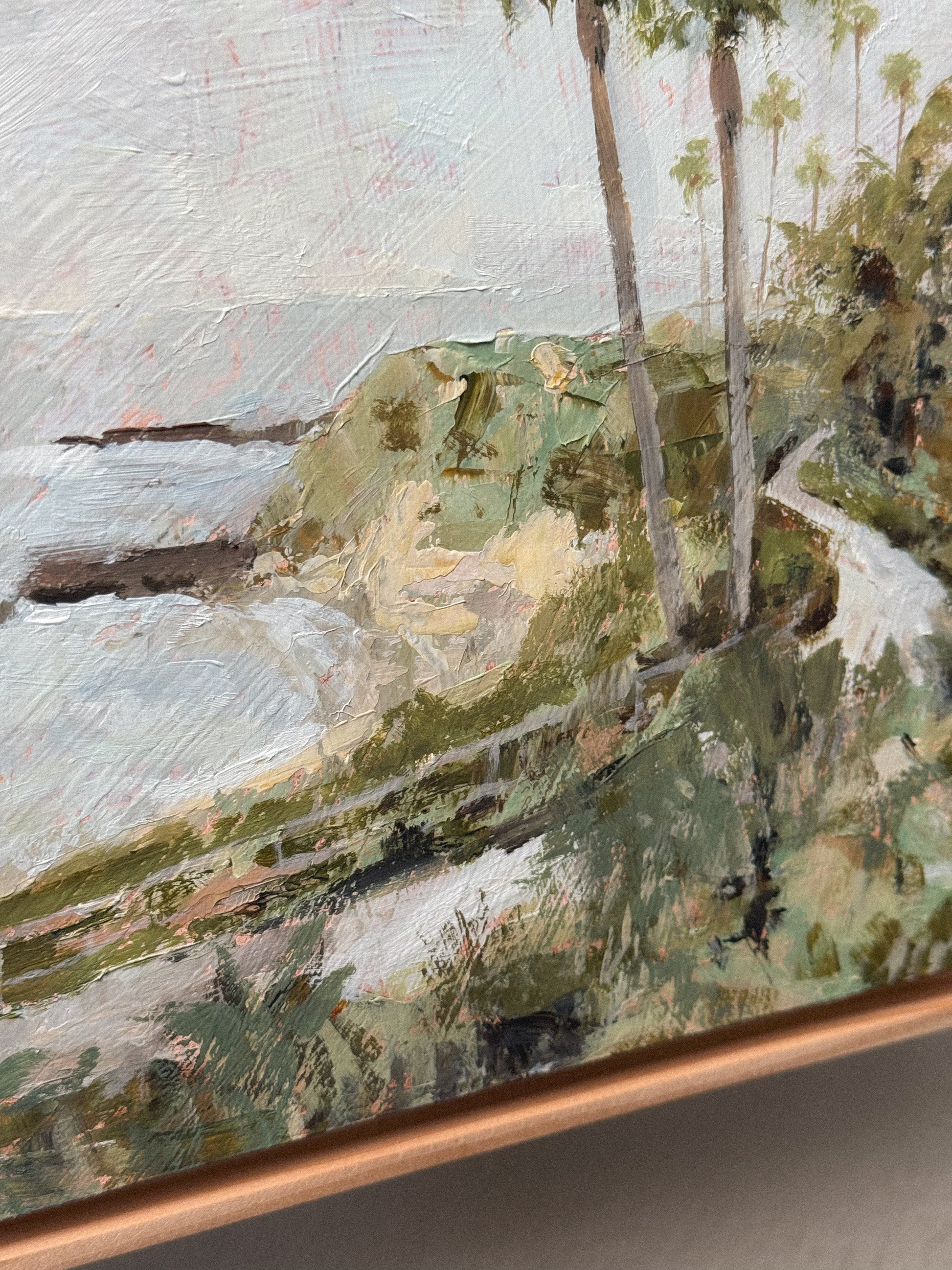 An acrylic painting in a floater wood frame, depicting the view of Treasure Island from the Montage Resort in Laguna Beach, CA. 